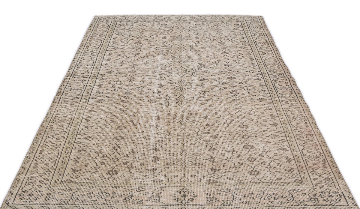 Beige and grey distressed rug with a traditional floral medallion pattern and a detailed border on a white background.