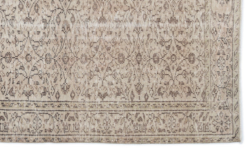 Load image 1 in gallery view. Beige and taupe distressed rug with a traditional floral medallion pattern and a detailed border.