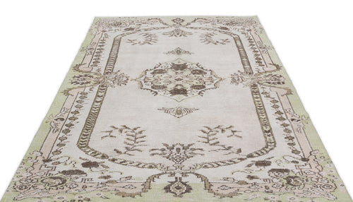 Load image 1 in gallery view. Cream and sage green vintage-style rug with a central brown floral medallion and ornate border on a white background.
