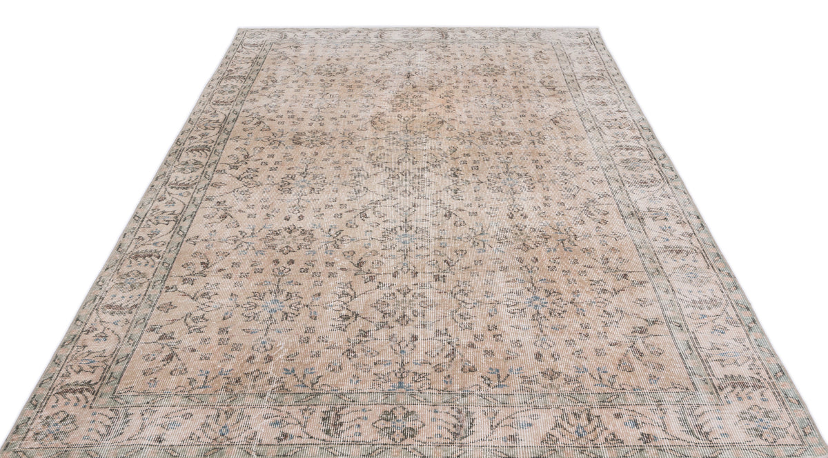 Beige and grey vintage-style rug with a distressed floral medallion pattern and a detailed border.