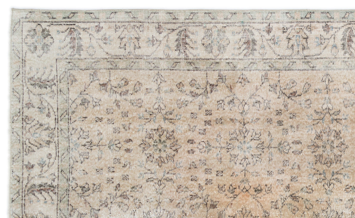 Beige and cream traditional rug with a distressed floral medallion pattern and a detailed border.