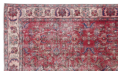 Load image 1 in gallery view. Distressed red Persian-style rug with a floral medallion pattern and a cream border featuring blue and red floral motifs.