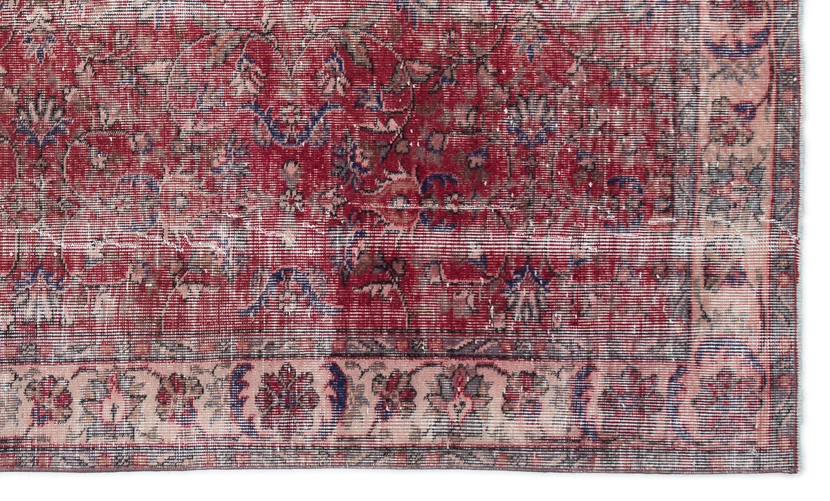 Distressed red traditional rug with blue and beige floral medallion patterns and a wide decorative border.