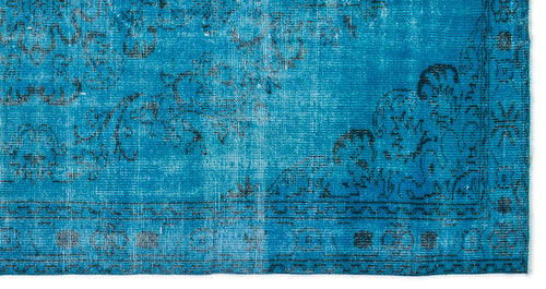 Load image 1 in gallery view. Bright blue rug with a distressed black floral medallion pattern and a geometric border.