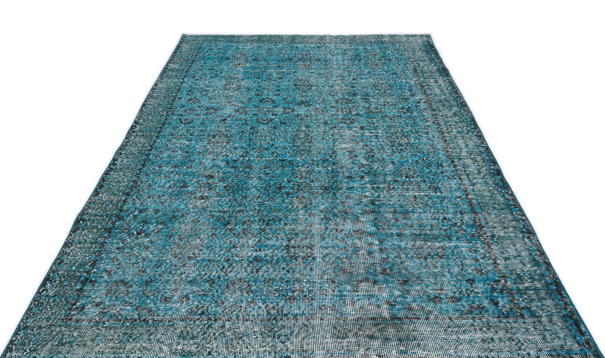 Teal and black distressed vintage-style rug with an intricate traditional medallion pattern on a white background.