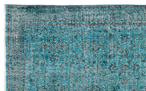 Load image 1 in gallery view. Teal and black distressed vintage-style rug with a traditional floral medallion pattern and a geometric border.