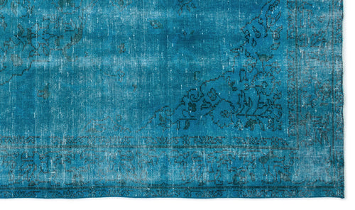 Load image 1 in gallery view. Teal distressed rug with a faded black floral medallion pattern and a decorative border.