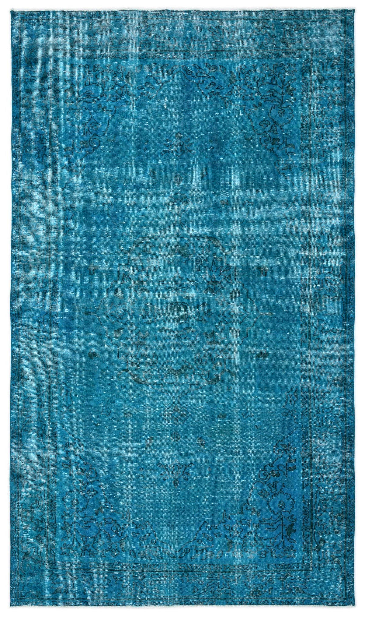 Teal distressed area rug with a faded central medallion and floral border pattern on a white background.