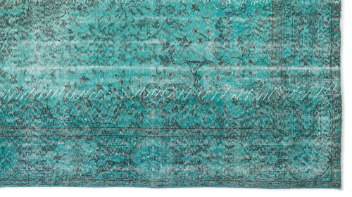 Load image 1 in gallery view. Teal and black distressed rug with a traditional floral medallion pattern and visible white stitched seam detail.