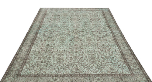 Load image 1 in gallery view. Mint green and brown distressed area rug with a traditional floral medallion pattern and a wide decorative border.
