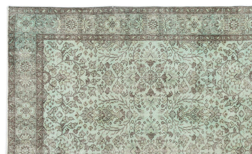 Load image 1 in gallery view. Distressed mint green and brown rug with a traditional floral medallion pattern and a decorative border.