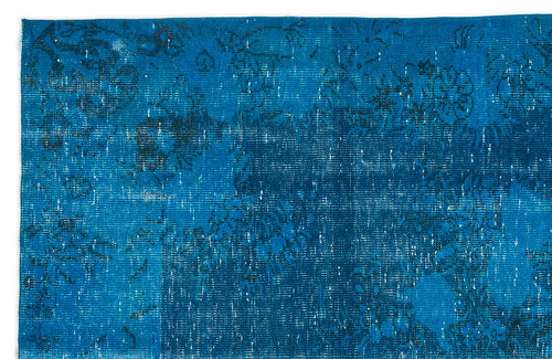 Load image 1 in gallery view. Bright blue distressed rug with a faded black floral medallion pattern.