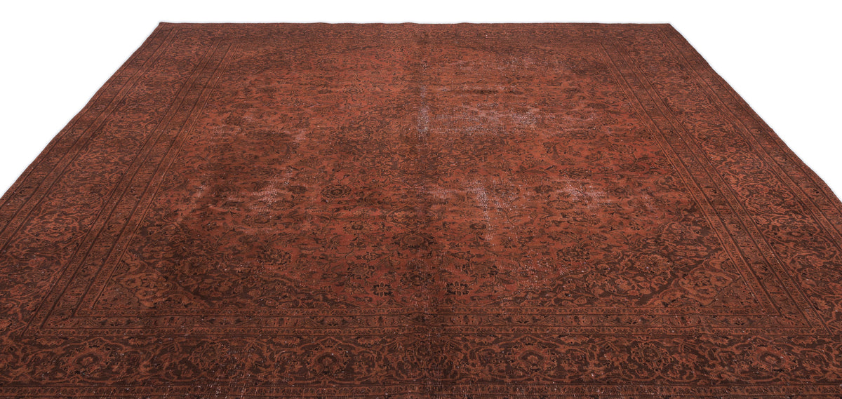 Deep red and dark brown traditional rug with an intricate floral medallion pattern and a wide decorative border.