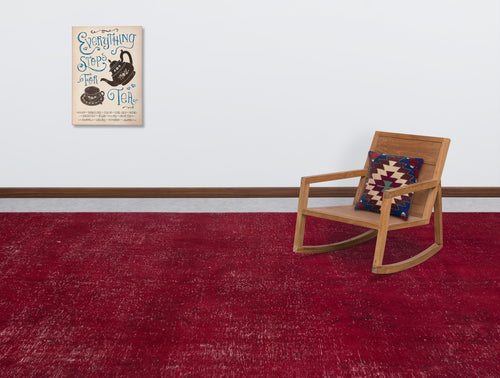 Load image 1 in gallery view. Solid deep red distressed rug in a room with a wooden rocking chair and tea-themed wall art.