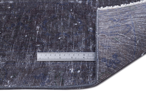 Load image 1 in gallery view. Distressed charcoal and blue rug with white flecks, showing a corner fold and a metal ruler for scale.