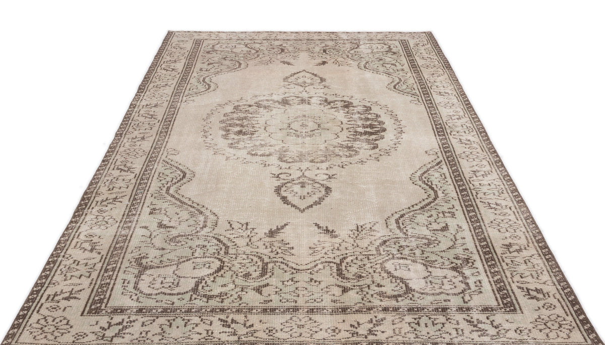 Beige and brown distressed traditional rug with a central floral medallion and ornate border pattern on a white background.