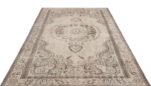 Load image 1 in gallery view. Beige and brown distressed traditional rug with a central floral medallion and ornate border pattern on a white background.