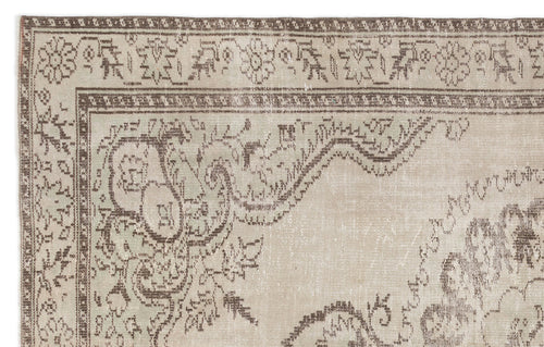 Load image 1 in gallery view. Beige and brown vintage-style rug with a distressed floral medallion pattern and a decorative border.