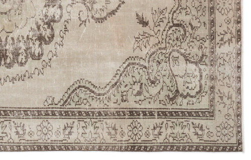 Load image 1 in gallery view. Beige and brown distressed rug with a traditional floral medallion pattern and a detailed geometric border.