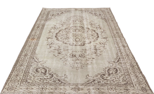 Load image 1 in gallery view. Beige and brown distressed vintage-style rug with a central floral medallion and ornate border on a white background.