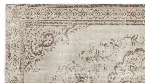 Load image 1 in gallery view. Beige and brown vintage-style rug with a distressed floral medallion pattern and a decorative border.