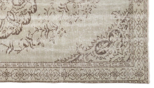 Load image 1 in gallery view. Beige and brown rug with a distressed floral medallion pattern and a geometric border.