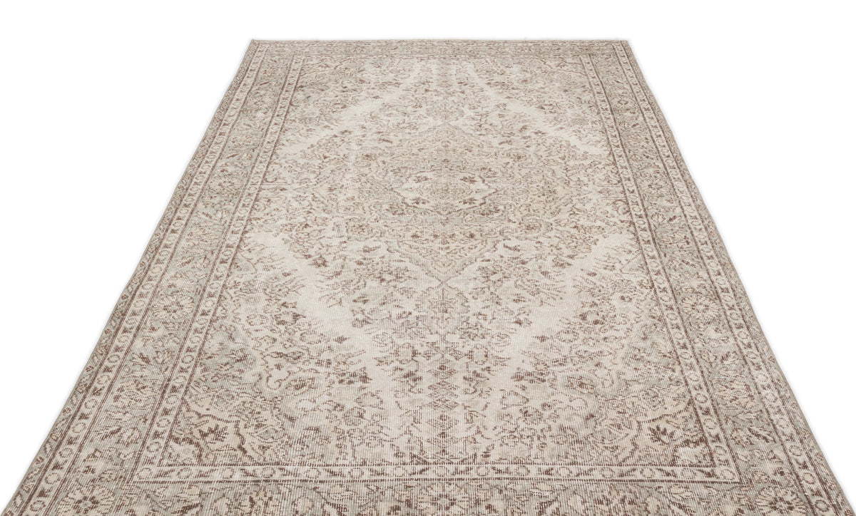 Beige and taupe area rug with a distressed traditional medallion pattern and a detailed border on a white background.