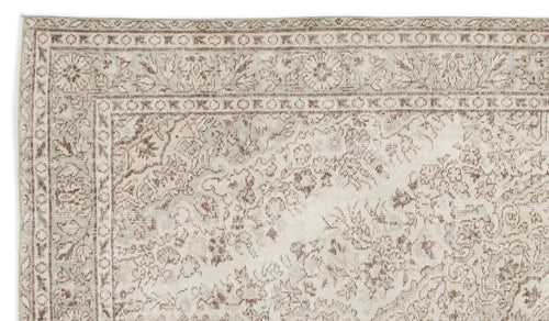Load image 1 in gallery view. Beige and taupe traditional rug with a distressed floral medallion pattern and a geometric border.