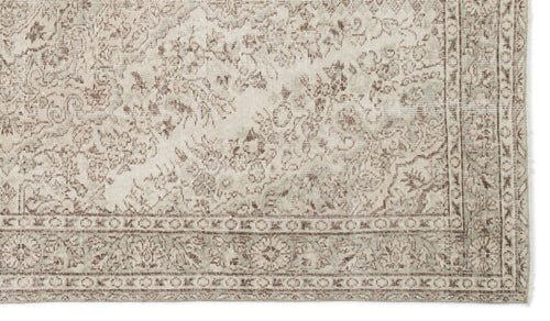 Load image 1 in gallery view. Beige and taupe traditional rug with a distressed floral medallion pattern and a detailed geometric border.