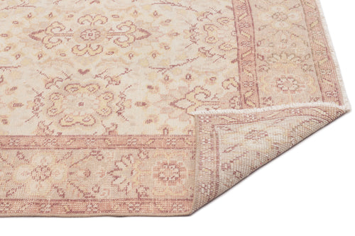 Load image 1 in gallery view. Beige and dusty rose traditional medallion rug with a folded corner on a white background.