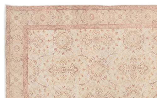 Load image 1 in gallery view. Beige and muted rose traditional rug with a faded floral medallion pattern and a detailed border.
