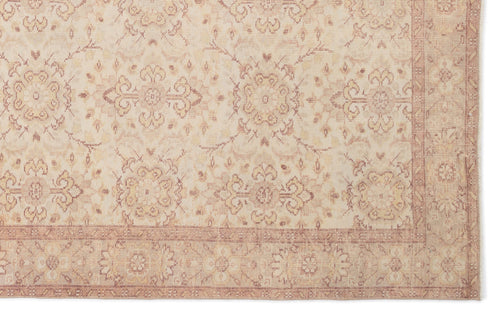 Load image 1 in gallery view. Beige and muted rose traditional rug with a repeating floral medallion pattern and a decorative border.
