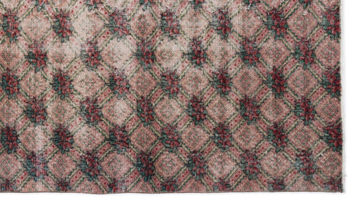 Load image 1 in gallery view. Distressed pink rug with a green and red floral diamond lattice pattern.