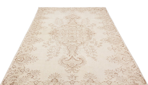 Load image 1 in gallery view. Cream and beige area rug with a faded traditional floral medallion pattern on a white background.