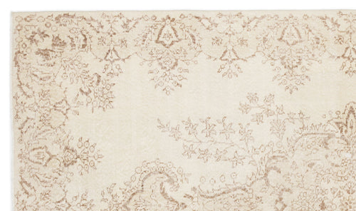Load image 1 in gallery view. Cream rug with a distressed, light brown floral and paisley pattern.