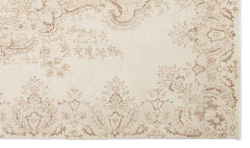 Load image 1 in gallery view. Cream and beige rug with a distressed, traditional floral medallion pattern.