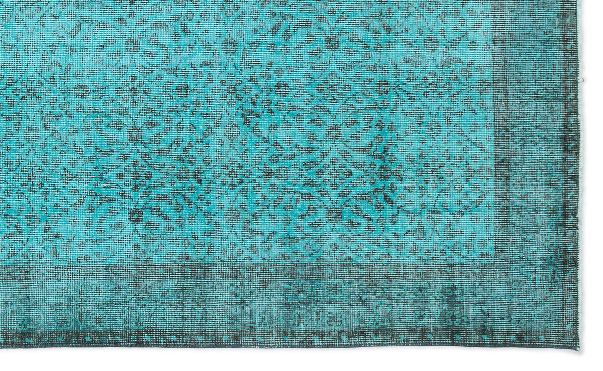 Turquoise and black rug with a distressed traditional floral medallion pattern and a wide decorative border.