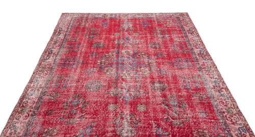 Load image 1 in gallery view. Distressed red vintage-style rug with a faded central medallion and floral motifs in blue and cream.