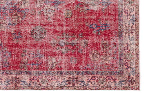 Load image 1 in gallery view. Distressed red rug with a faded floral medallion pattern and a light pink border with blue and dark red accents.