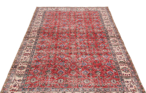 Load image 1 in gallery view. Red vintage-style rug with a distressed floral pattern and a cream border, isolated on a white background.