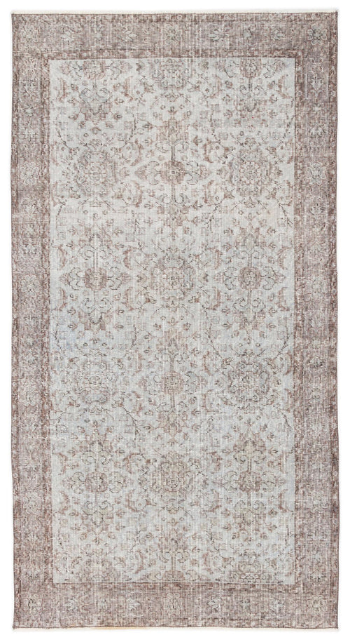 Load image 1 in gallery view. Distressed taupe and light grey rug with a traditional floral medallion pattern and a wide decorative border.