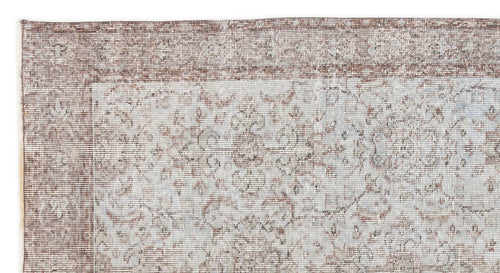 Load image 1 in gallery view. Distressed brown and light blue rug with a traditional floral medallion border and central pattern.
