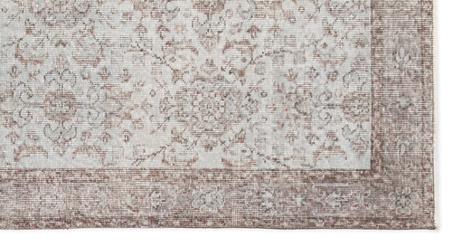 Load image 1 in gallery view. Light gray and brown rug with a distressed traditional floral medallion pattern and a wide decorative border.