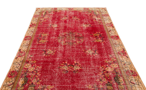 Load image 1 in gallery view. Distressed red vintage rug with a central floral medallion and beige patterned border.