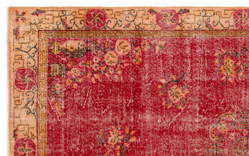 Load image 1 in gallery view. Red vintage-style rug with a distressed floral pattern and a beige geometric border.