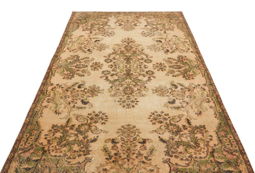 Load image 1 in gallery view. Beige and olive green vintage-style rug with a distressed floral medallion pattern on a white background.