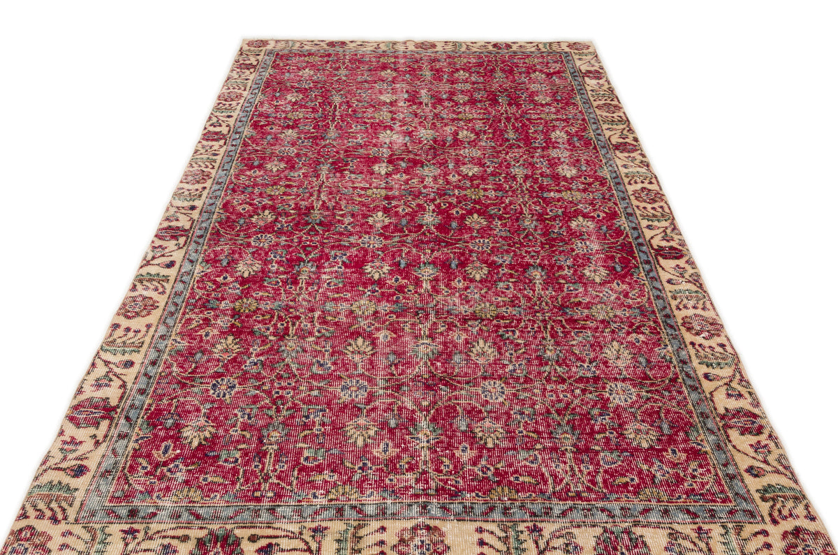 Red and cream traditional rug with a distressed floral pattern and a wide decorative border on a white background.