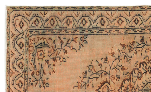 Load image 1 in gallery view. Peach and brown distressed rug with a traditional floral medallion pattern and geometric border.