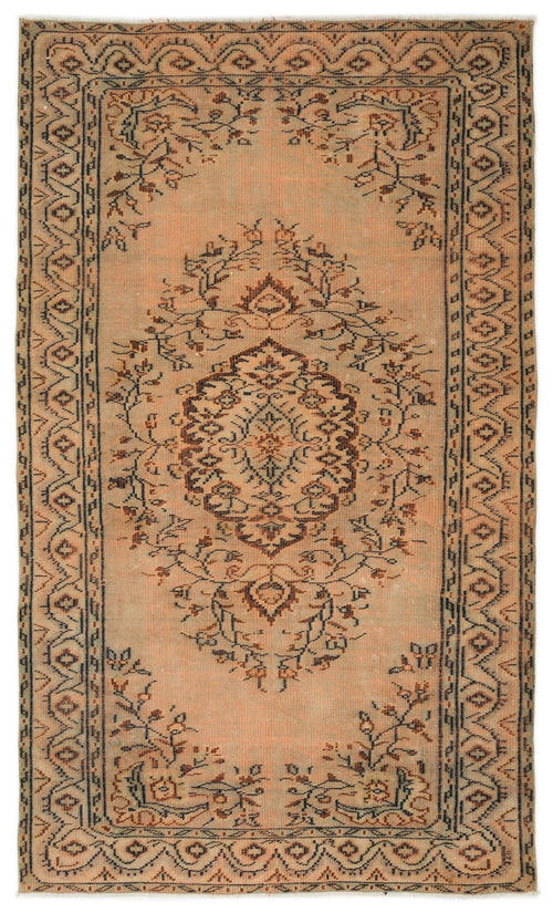 Load image 1 in gallery view. Distressed peach and brown rug with a central floral medallion and a geometric border pattern.