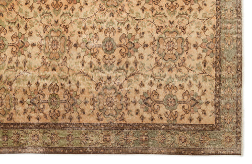 Load image 1 in gallery view. Beige rug with a repeating floral medallion pattern in sage green and brown, featuring a dark brown border.